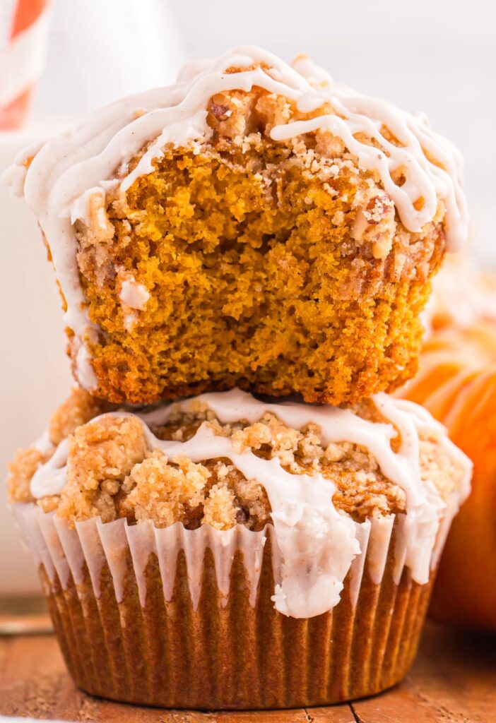 Stack of muffins with the top one with a bite taken out of it