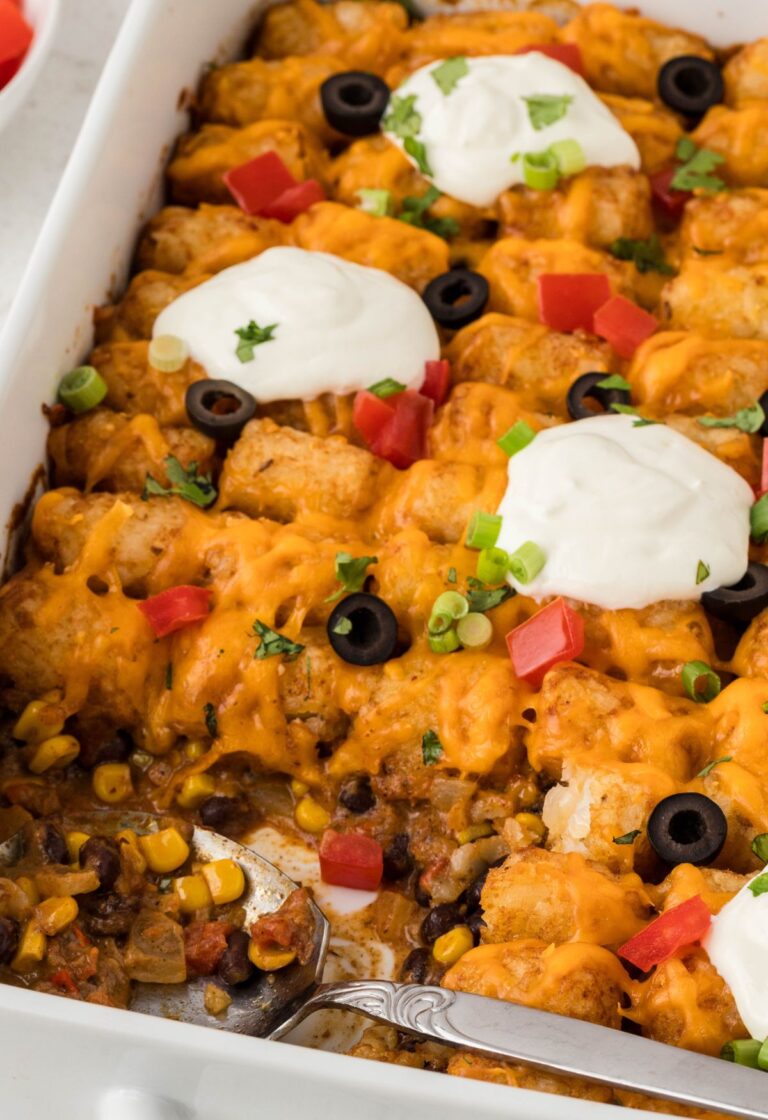 A baking dish with the casserole and tater tots on top