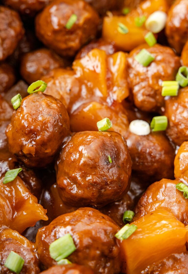 A hero shot of the meatballs up close with sweet and sour sauce and green onions.