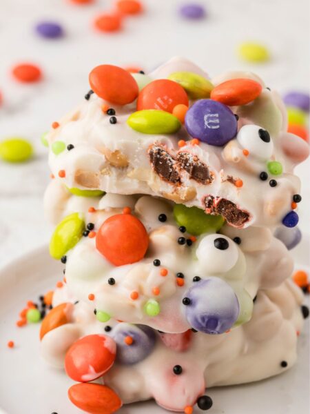 Stack of crockpot candy decorated for halloween.