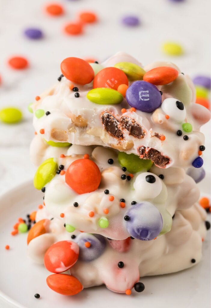 Stack of crockpot candy decorated for halloween. 