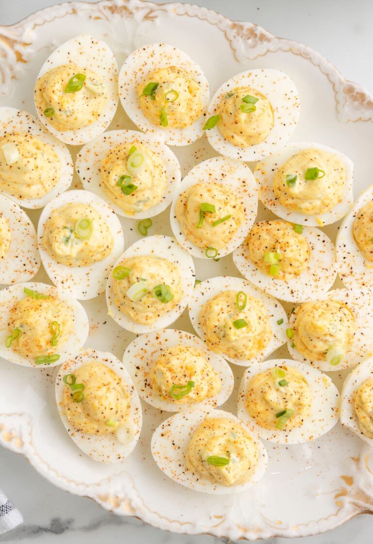 Platter of deviled eggs with cajun seasoning and ingredients