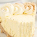Slice of eggnog pie with the front with a fork bite taken out of it