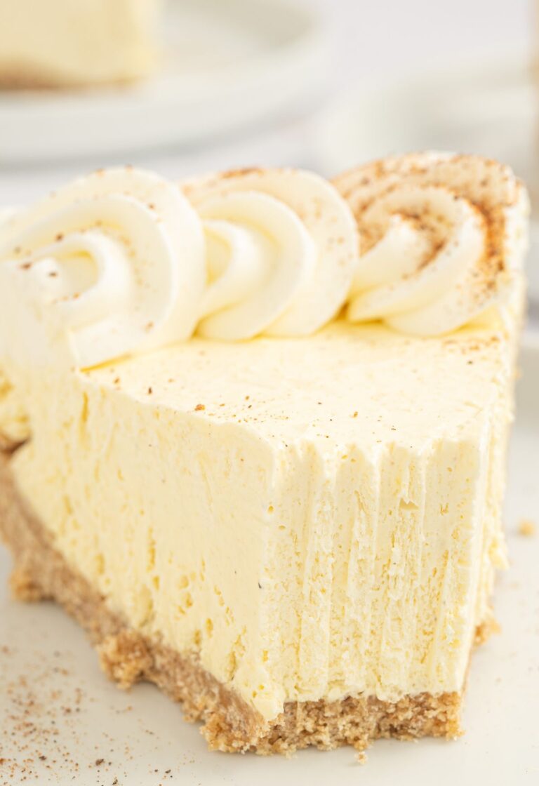 Slice of eggnog pie with the front with a fork bite taken out of it