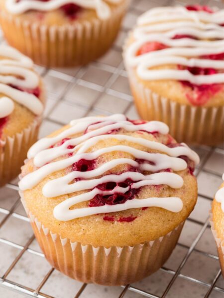 Glazed cranberry muffin on a cooling rack