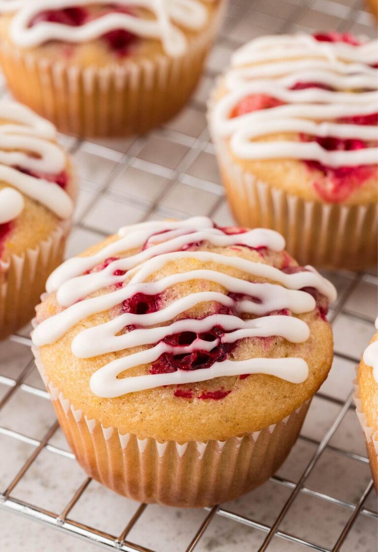 Glazed cranberry muffin on a cooling rack