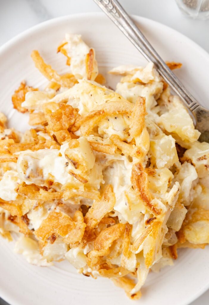 Serving of the French onion casserole on a white plate.