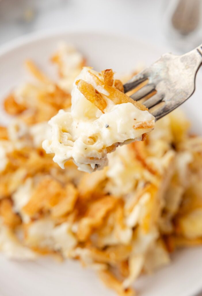 A fork with some of the cream casserole on it up close.