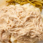 Serving of the chicken in the gravy sauce by green beans