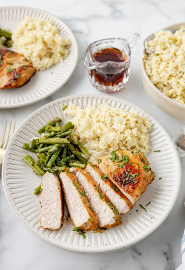 Overhead pic of the pork chops that are cooked ready to eat on a plate. 