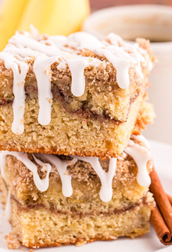 This scrumptious Banana Coffee Cake is the perfect sweet treat to your morning cup of coffee, a delightful afternoon snack, or as a delectable dessert. Made with ripe bananas, a hint of cinnamon, and topped with a crumble topping and buttery streusel. This coffee cake is so moist, full of banana flavor, and finished with a simple vanilla glaze.