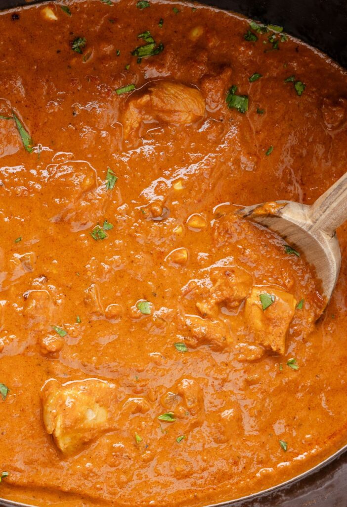 Inside of the slow cooker with the tikka masala in it, already cooked. 