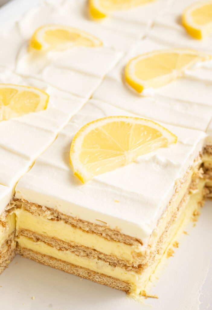 A layered icebox cake inside a pan showing the layers