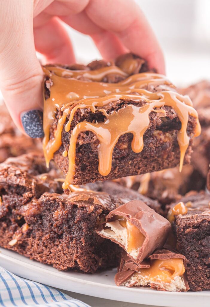 A hand holding a brownie