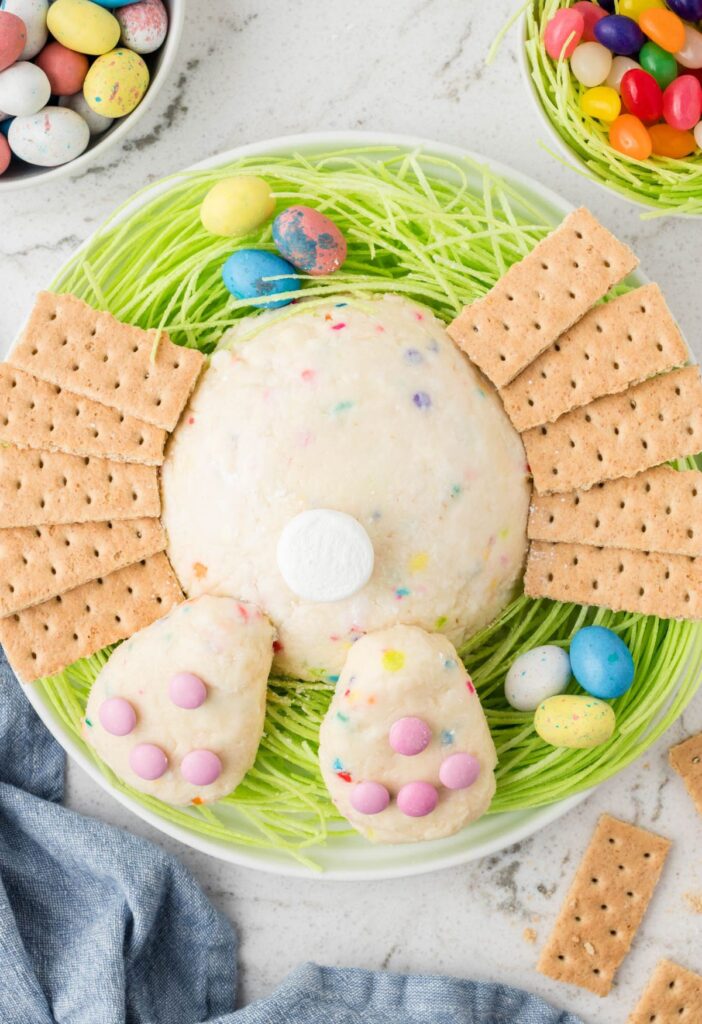 A wide overhead picture of the bunny butt cheeseball with easter candies around it. 