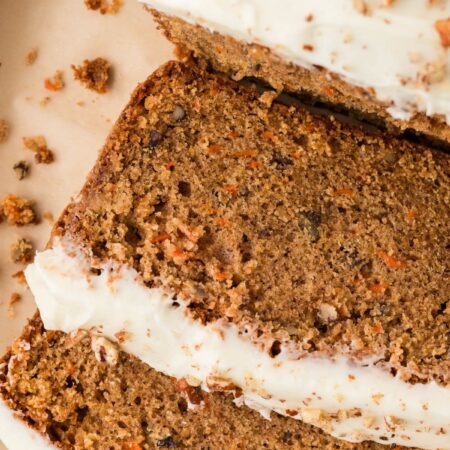 Overhead shot of the carrot cake bread cut into slices laying on a baking tray.