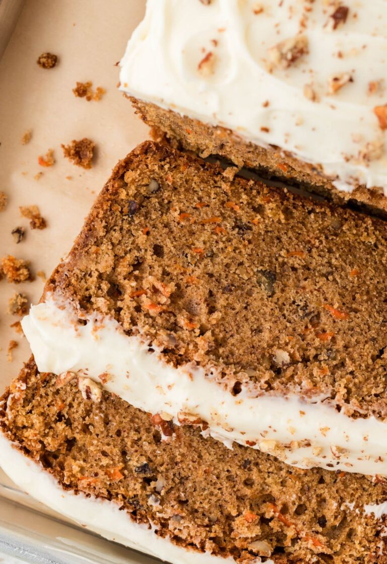 Overhead shot of the carrot cake bread cut into slices laying on a baking tray.