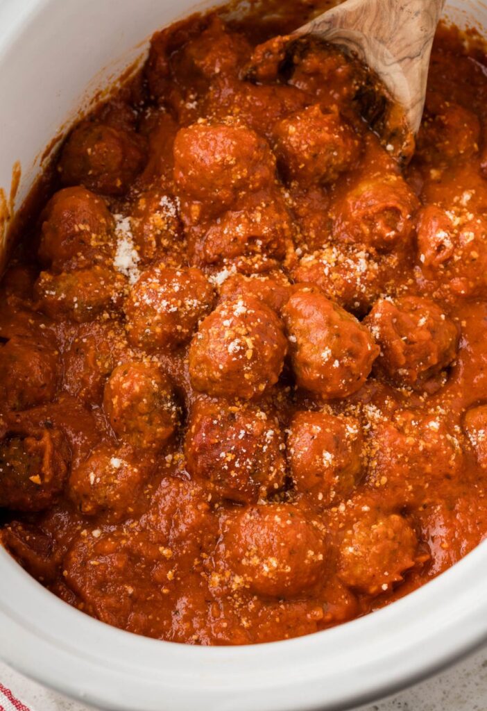 A crockpot of the marinara sauce with meatballs. 