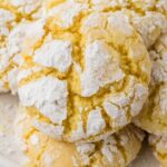 A white plate with several lemon cookies on it