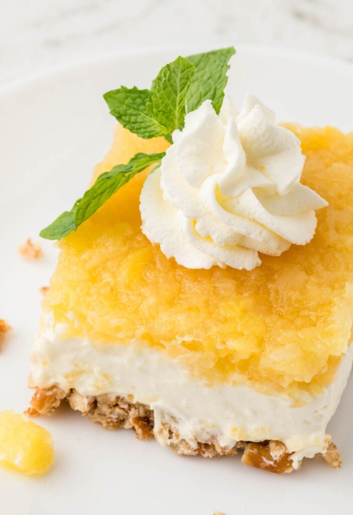 A slice of the pineapple salad with a mint leaf on top.
