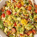 Top view of the salad with avocado, corn, red onion, and dressing