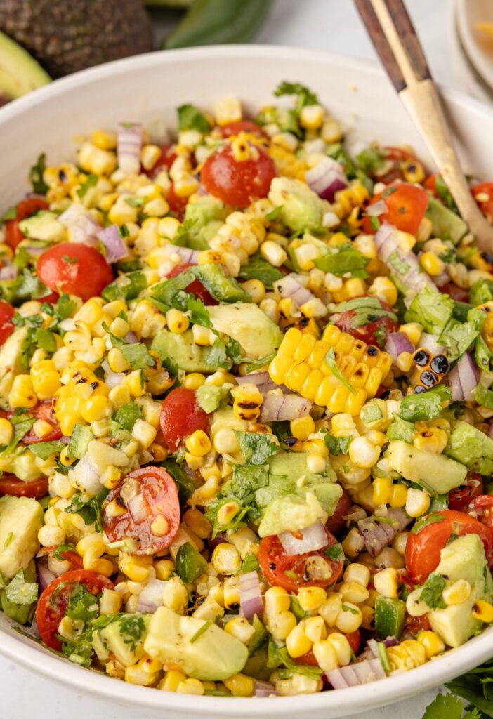 hero shot of corn salad ready to serve with serving spoon in it
