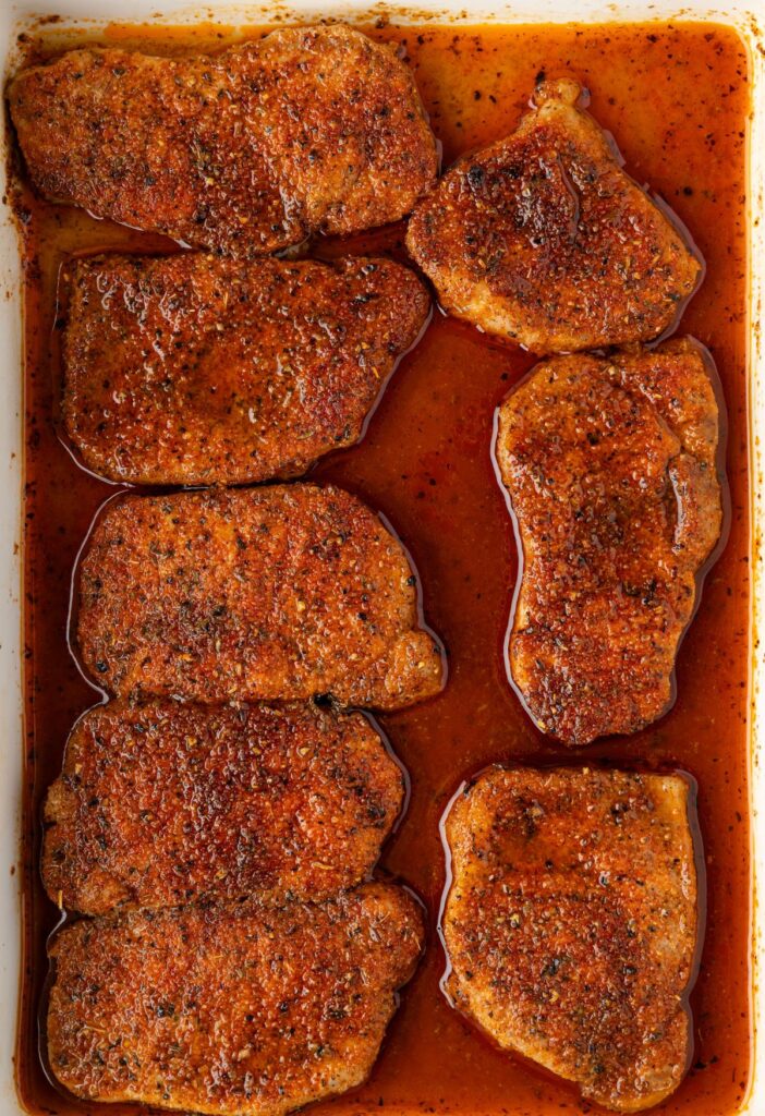 Overhead picture of the pan of baked brown sugar pork chops.