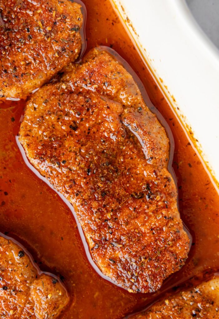 Close up image of the pork chop inside the pan