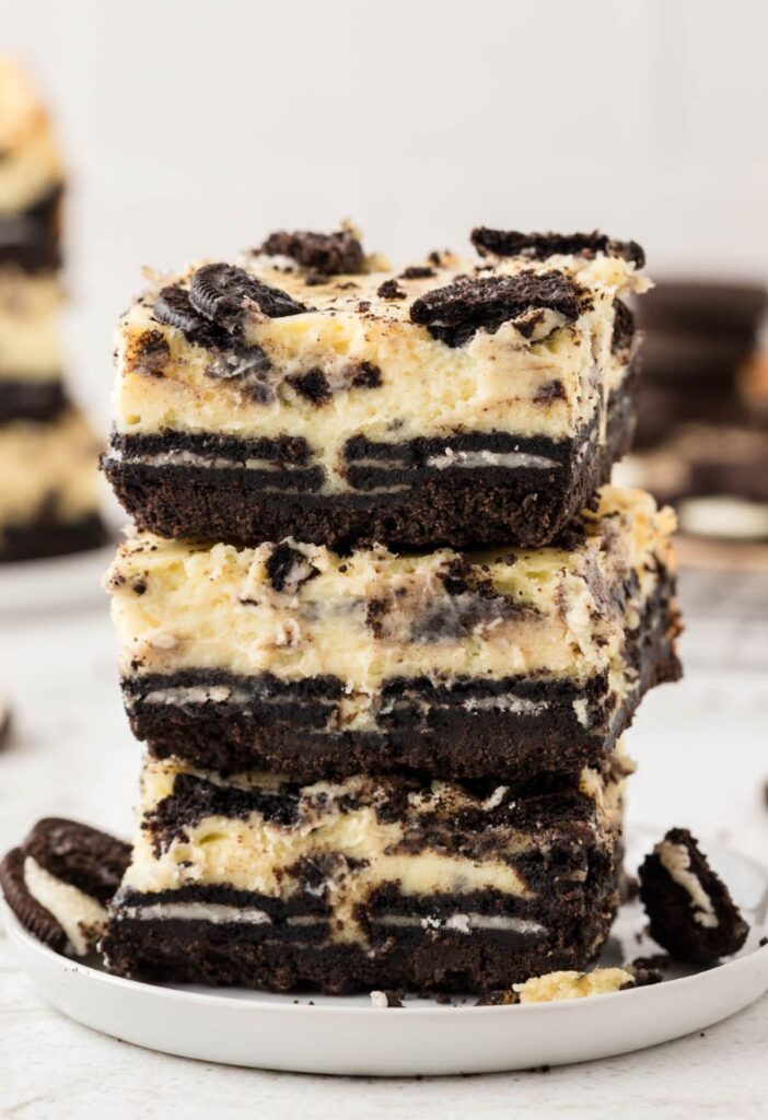Stack of cheesecake bars with oreo cookies. 