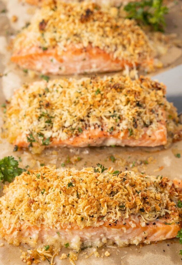 Salmon fillets on a sheet pan with a serving spatula