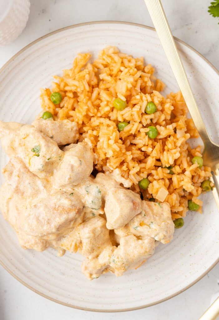 A serving plate of the pollo con crema with rice. 