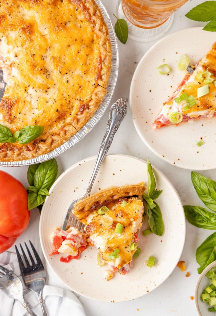 Overhead pic of the tomato pie with a plate with a slice of the savory pie on it. 
