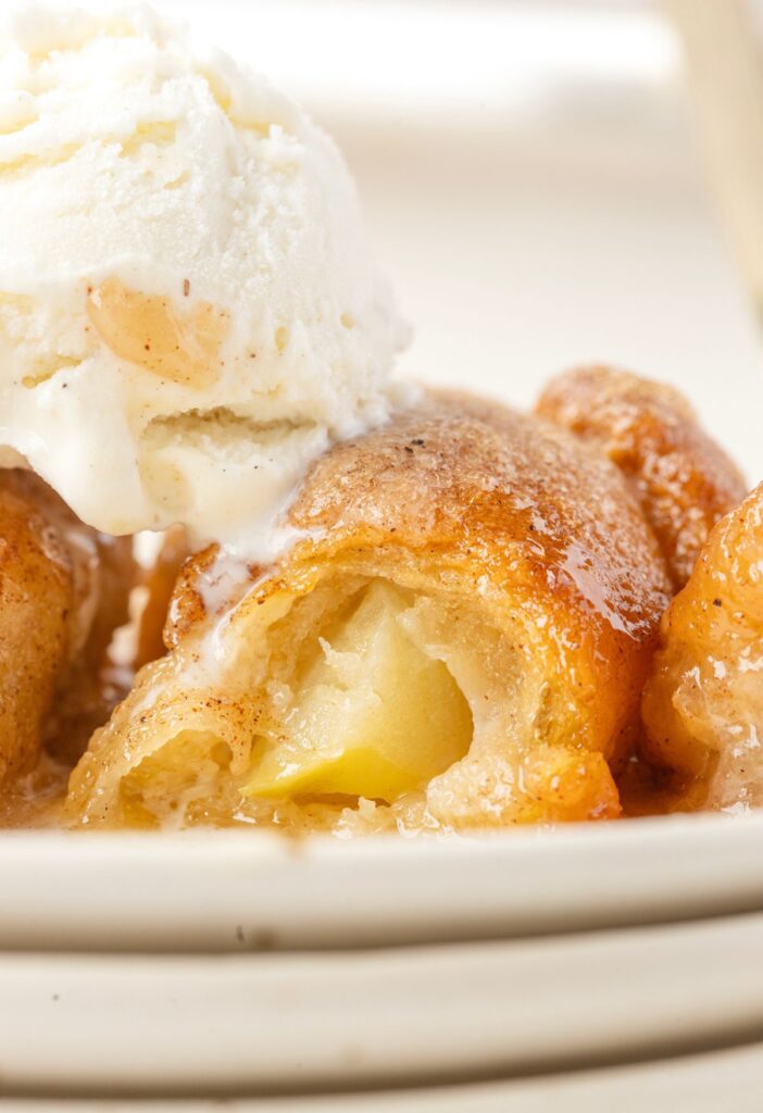 The inside of the baked apple dumpling topped with ice cream. 