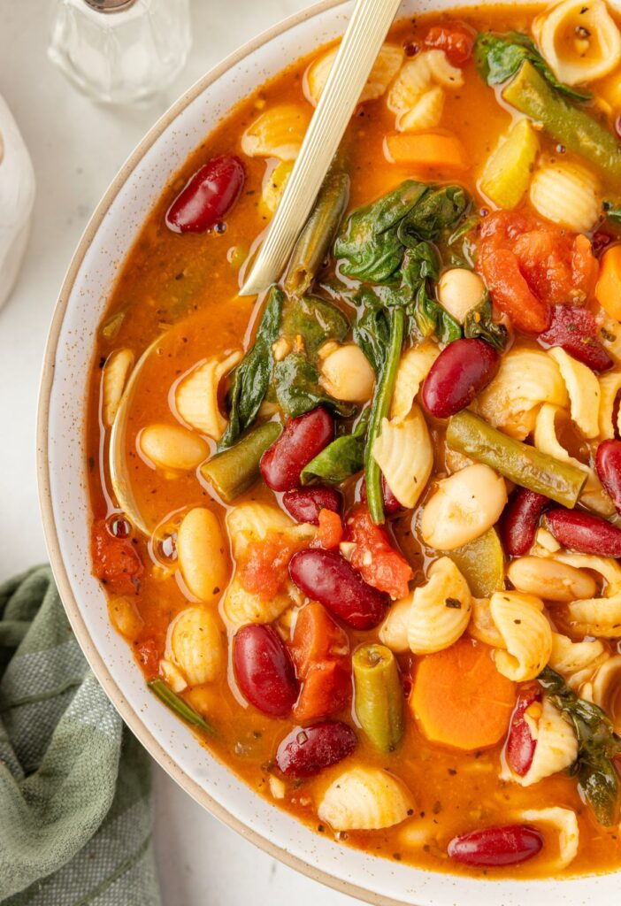 A bowl of soup with a spoon inside of it. 