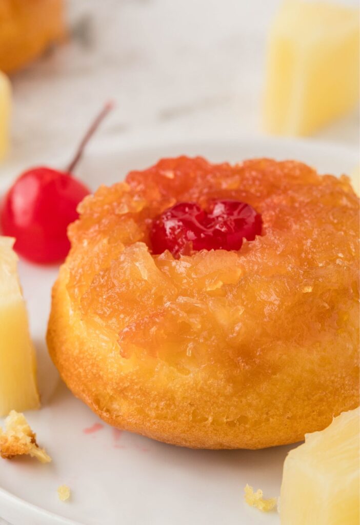 A baked mini cake with pineapple and cherry