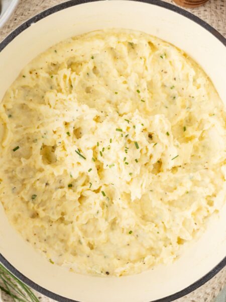 Top view of inside the pot with the mashed potatoes in it topped with fresh chives