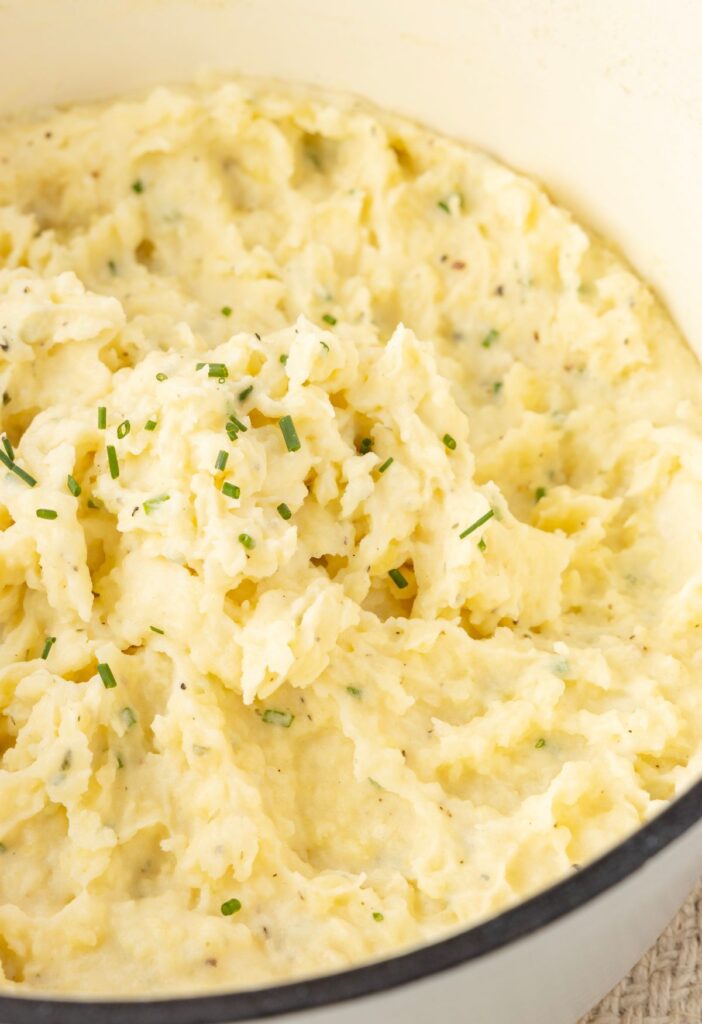 Side view of the pot of mashed potatoes with Boursin cheese.