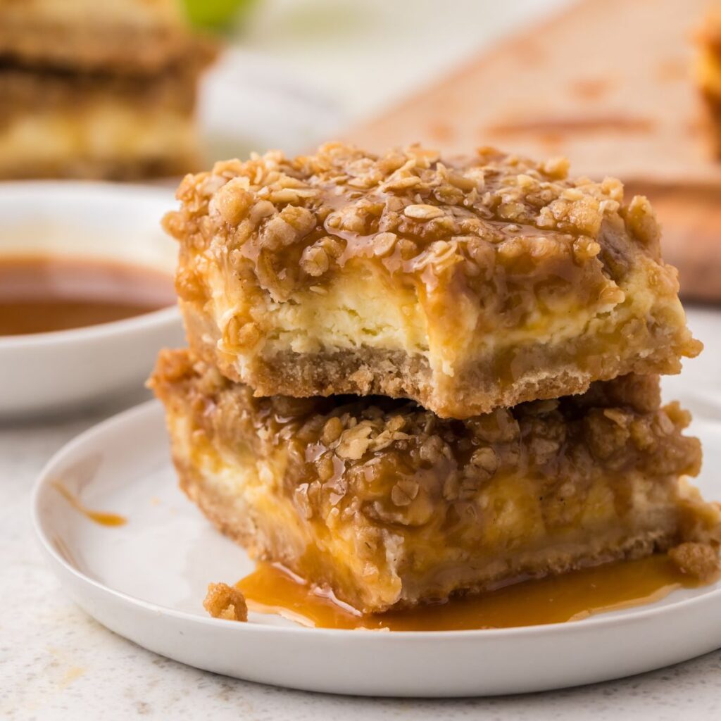 A bite taken out of the caramel apple cheesecake bar