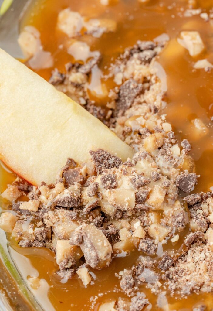 An apple slice inside the caramel apple fruit dip