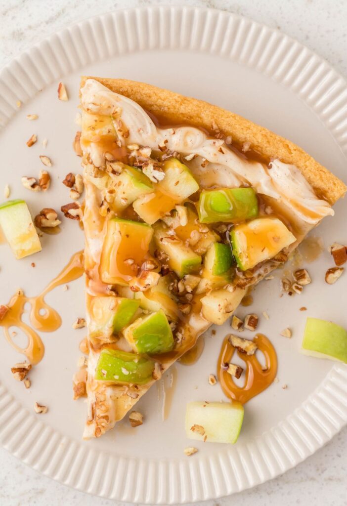 Once slice of the dessert pizza on a white plate.