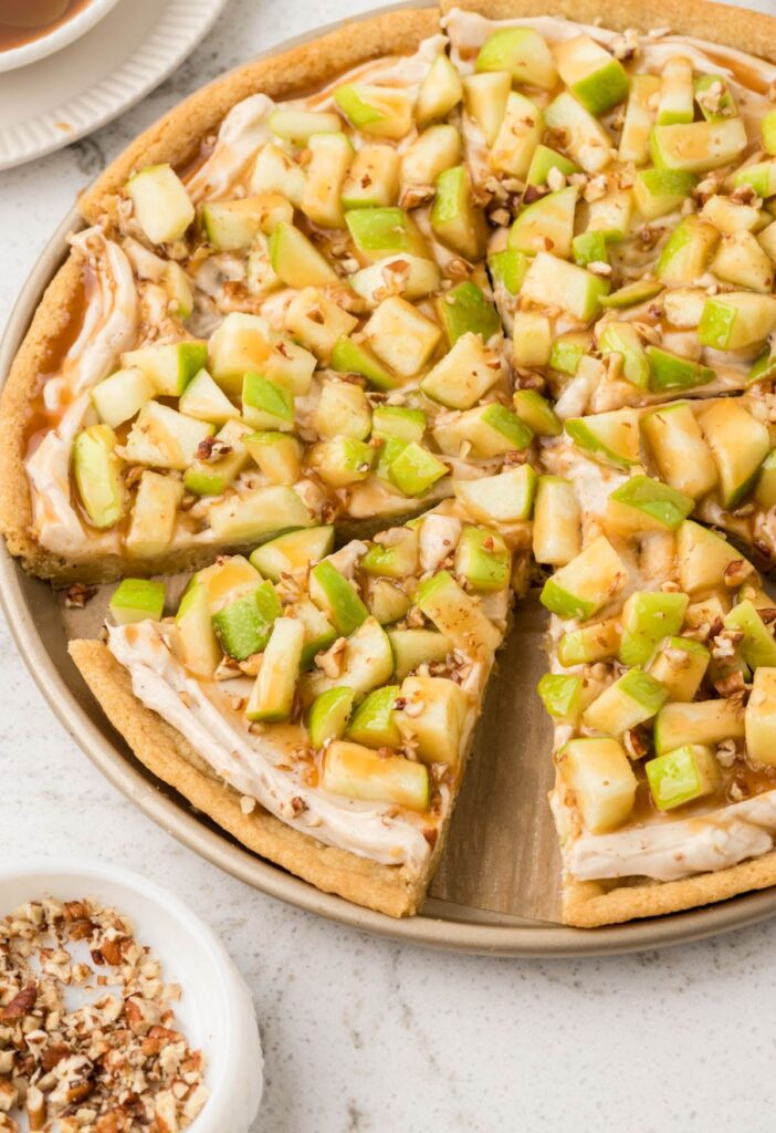 Hero shot of the baked dessert pizza with a slice cut out of it