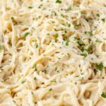 A skillet pan of the creamy pasta with cream cheese sauce.