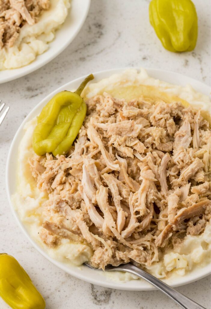 Serving of the chicken with pepperoncini peppers on a white plate