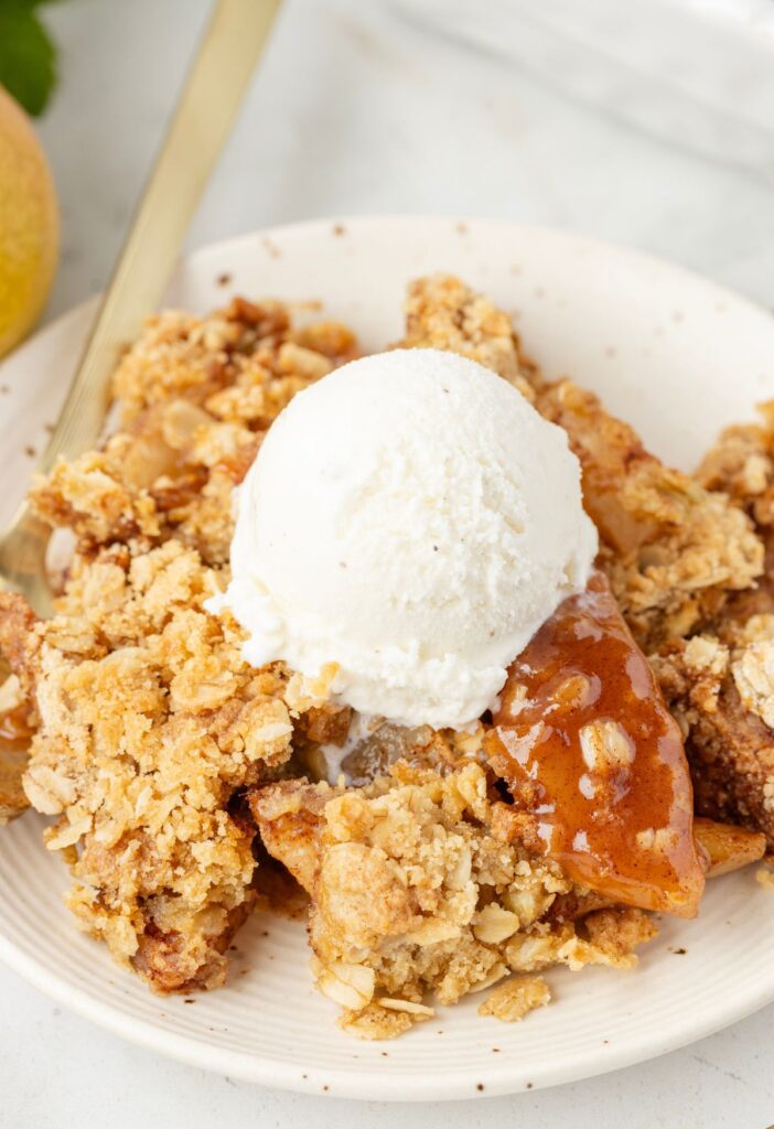 Serving of pear crisp with ice cream on top