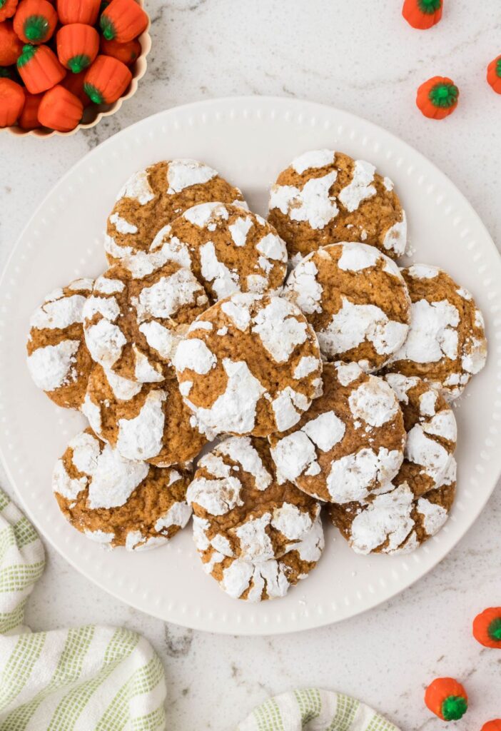 Overhead pic of the pumpkin crinkle cookies with candy pumpkins to the side. 