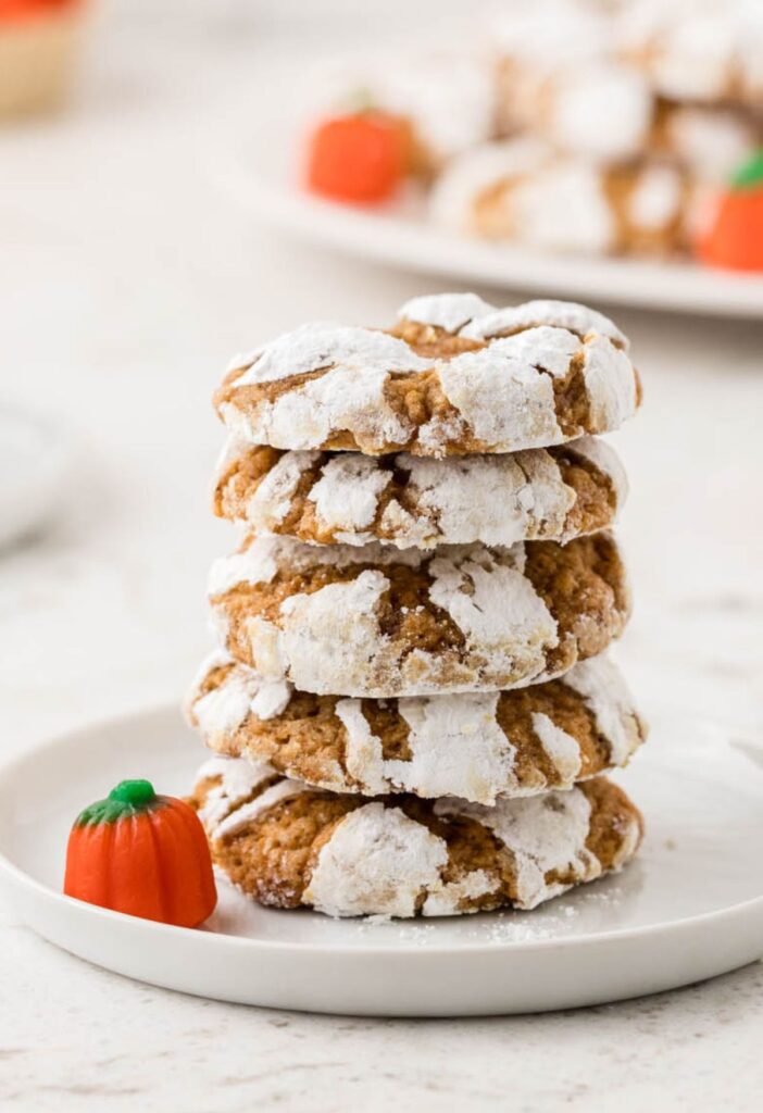 Stack of pumpkin crinkle cookies on a white plate. 