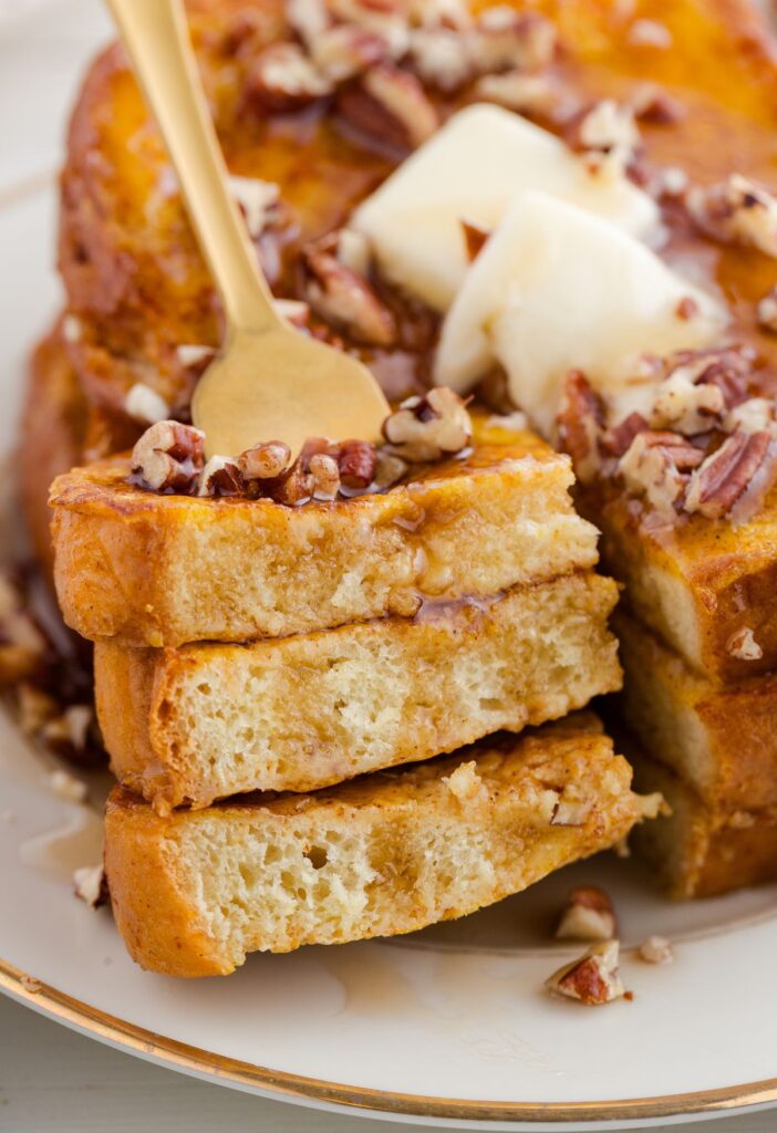 A fork inside a bite of French toast slices