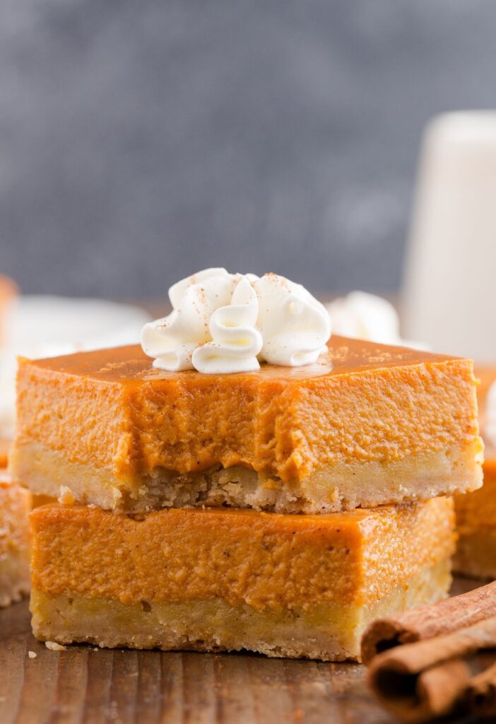 Pumpkin pie bars with a fork bite taken out of the front