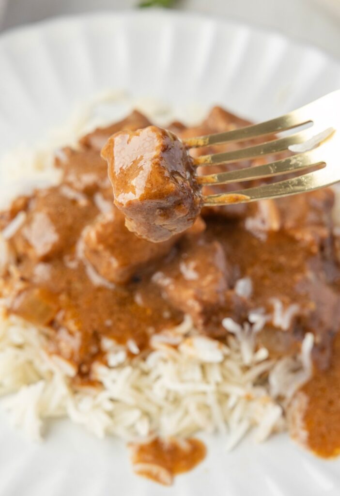 Close up of a piece of beef on a fork