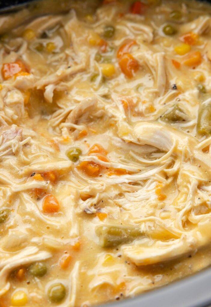 Hero shot of the cooked chicken pot pie filling inside the slow cooker. 